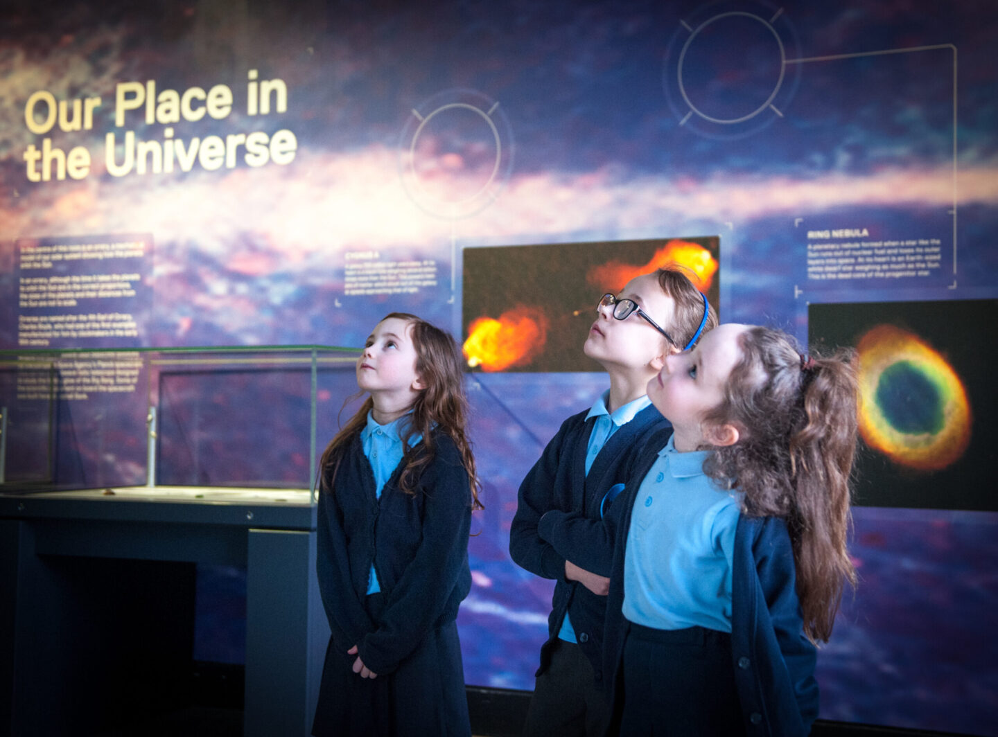 School children interacting with an exhibition.