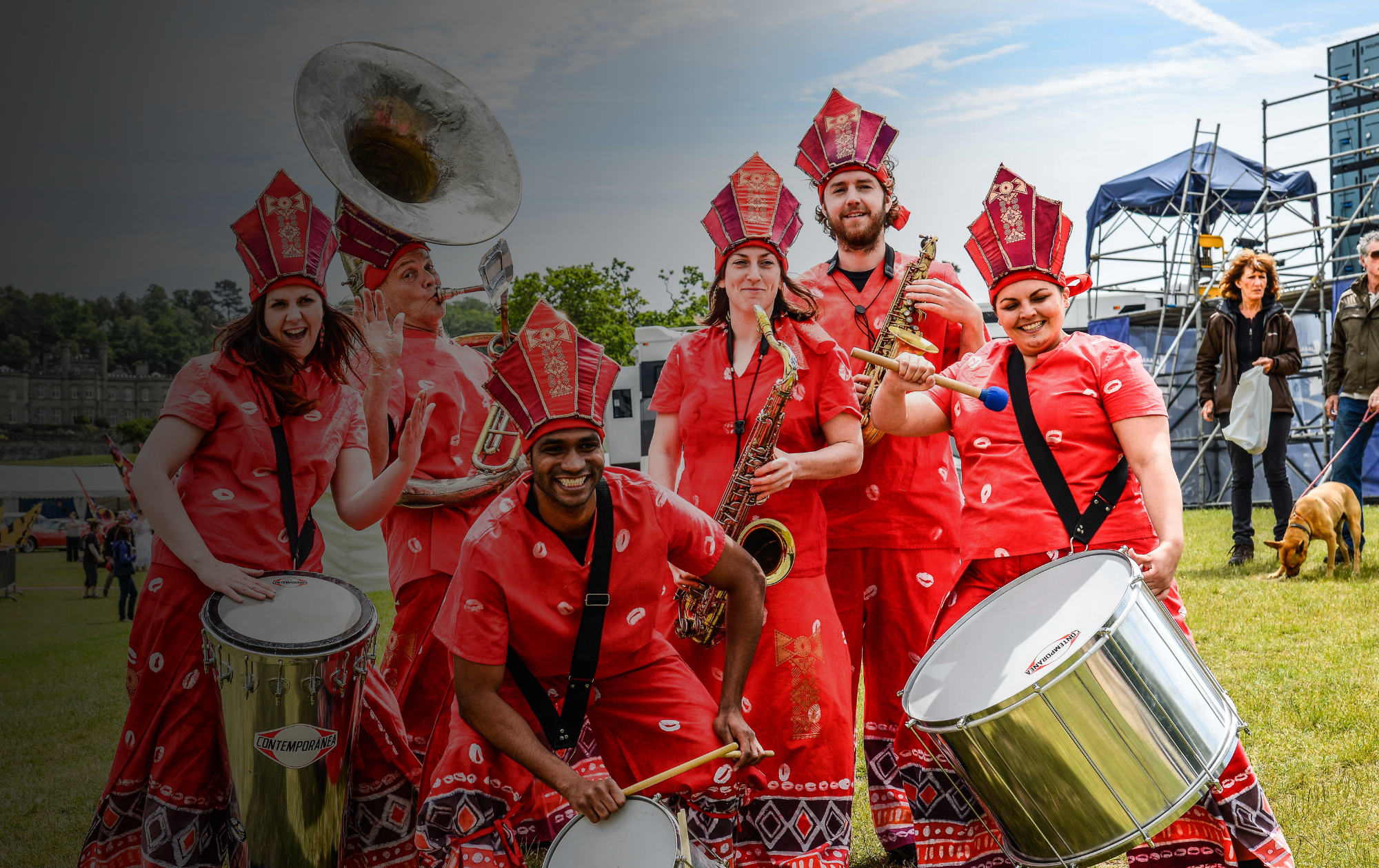 Global Grooves, a drum and brass band wearing red decorative attire.