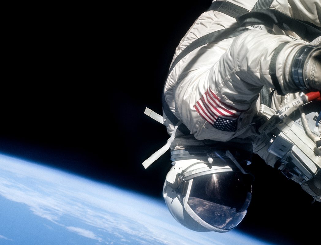 A photo of an astronaut suspended above planet Earth.