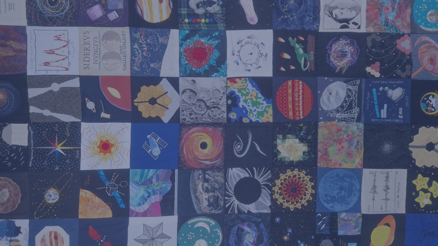 A photo of the RAS Bicentennial Quilt against a blue backdrop.