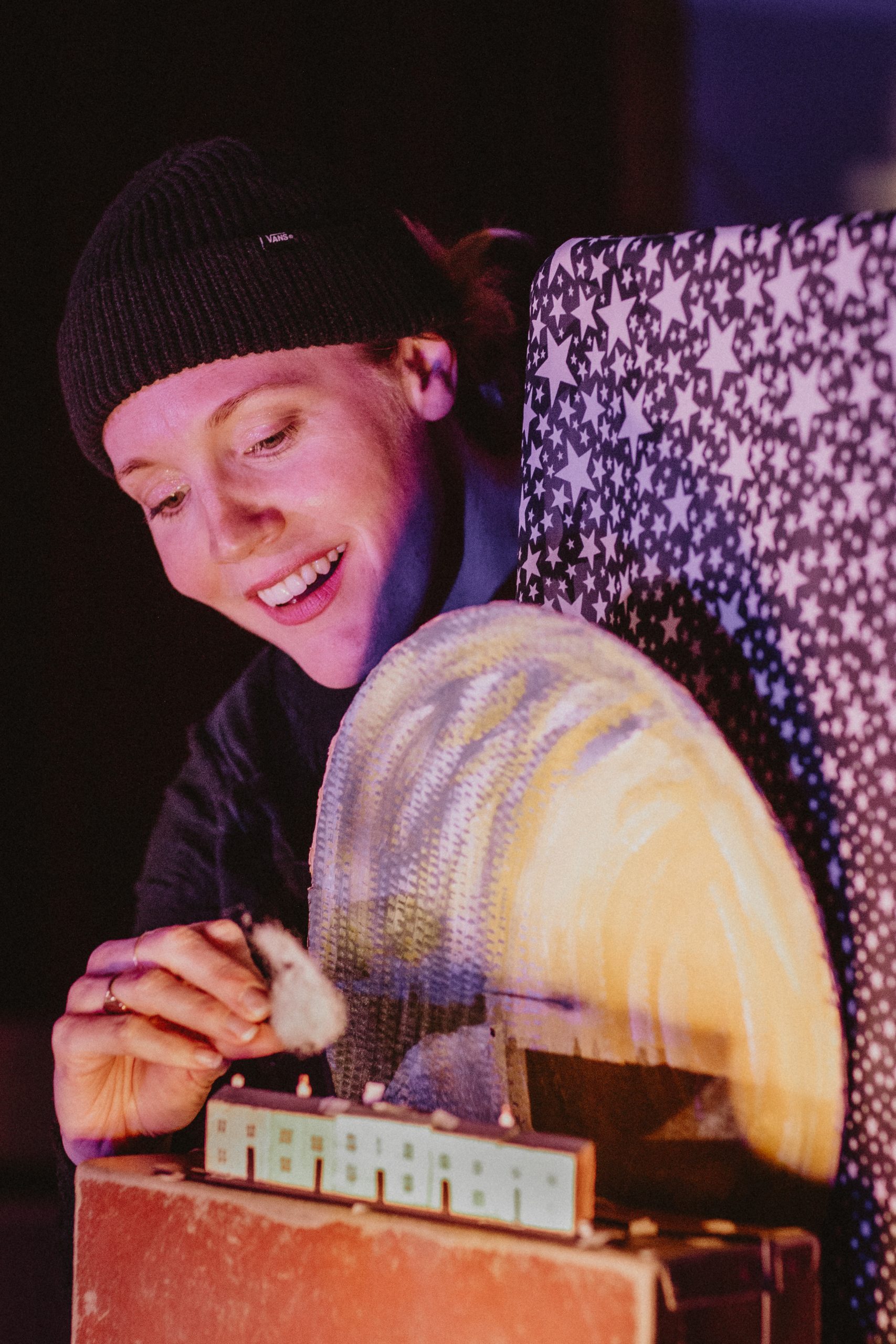 An actor performs with a puppetry prop of the moon. Credit: Goofus Theatre. All in a Mouse's Night.