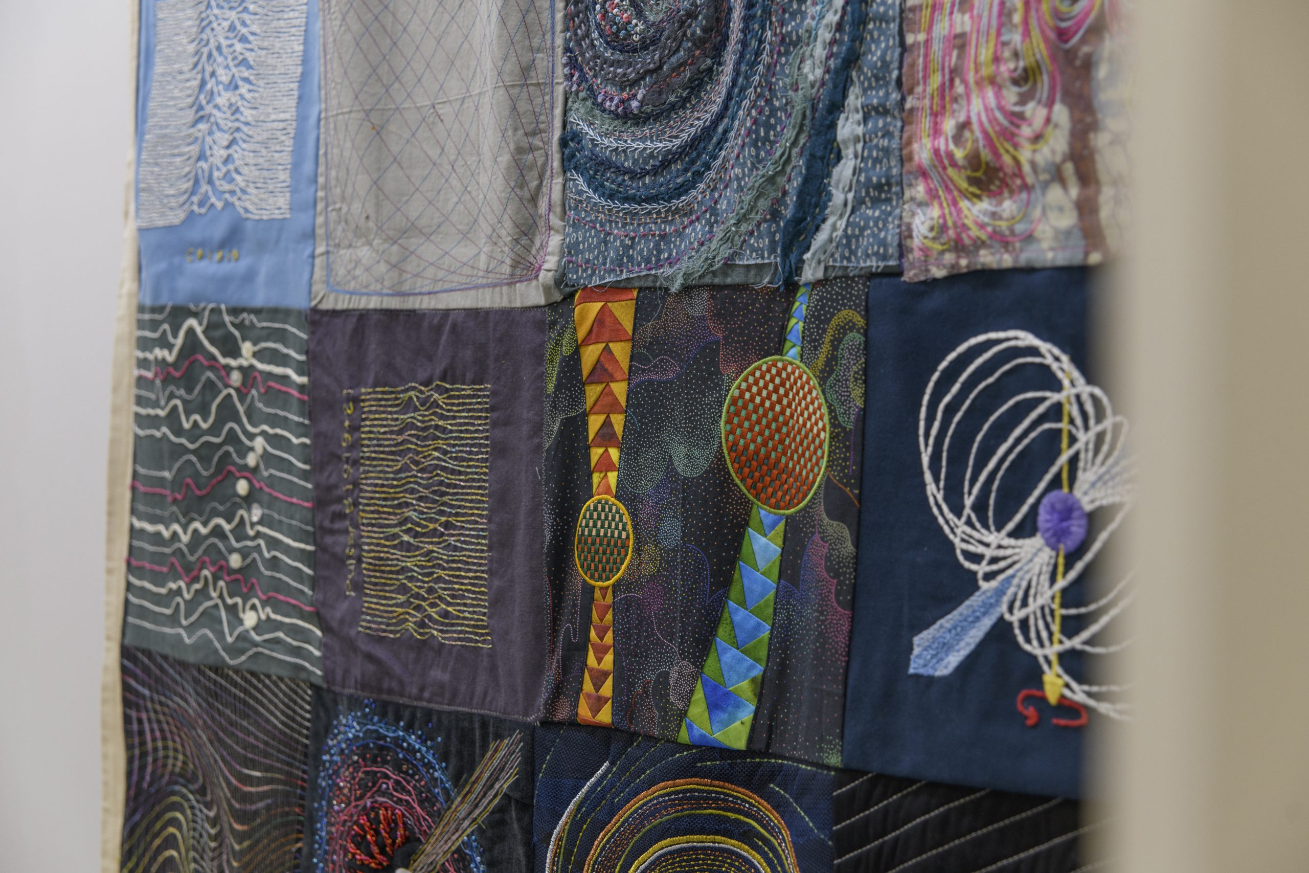 A close-up look at one of the quilts, depicting scientific phenomena.