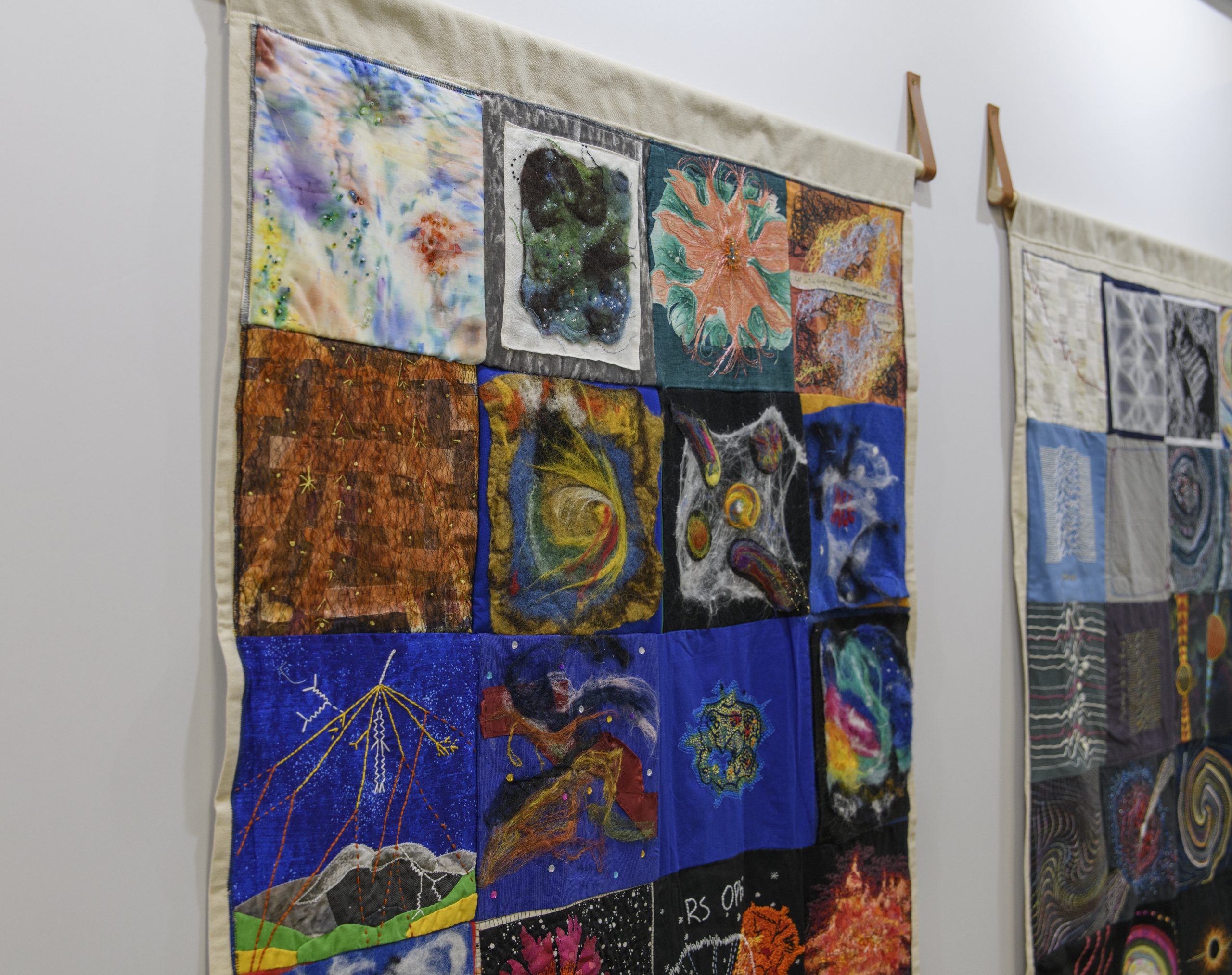 A close-up look at one of the quilts, depicting scientific phenomena.