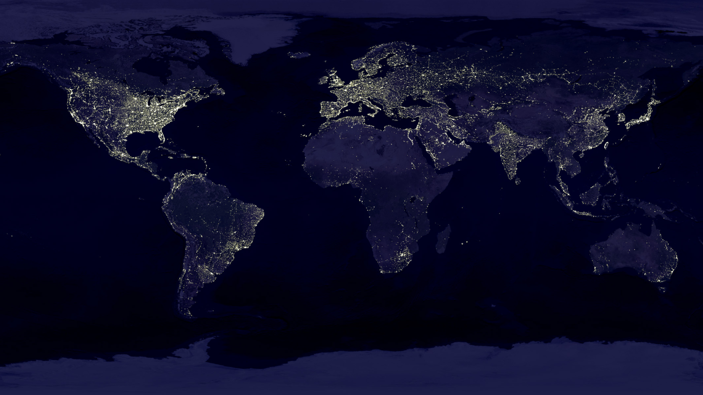 Image of satellite view of Earth at night showing global distribution of artificial lighting.
