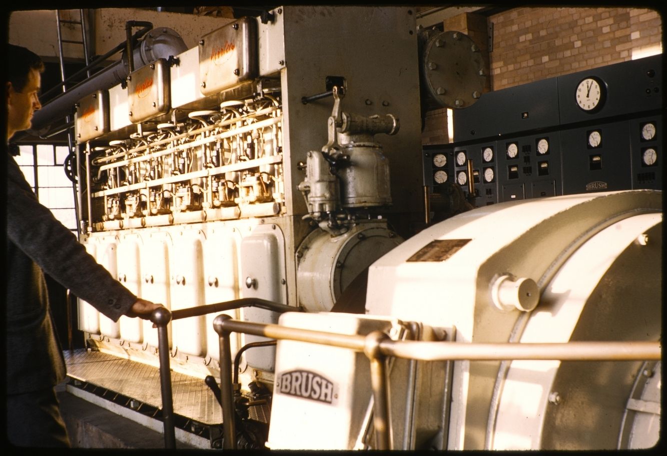 A gentleman looking at a 250KW generator.