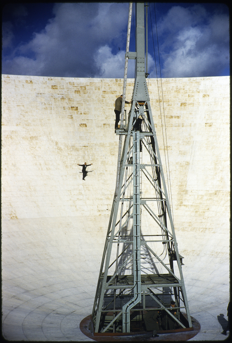 A gentleman with his arms raised walking along the dish of the Lovell Telescope