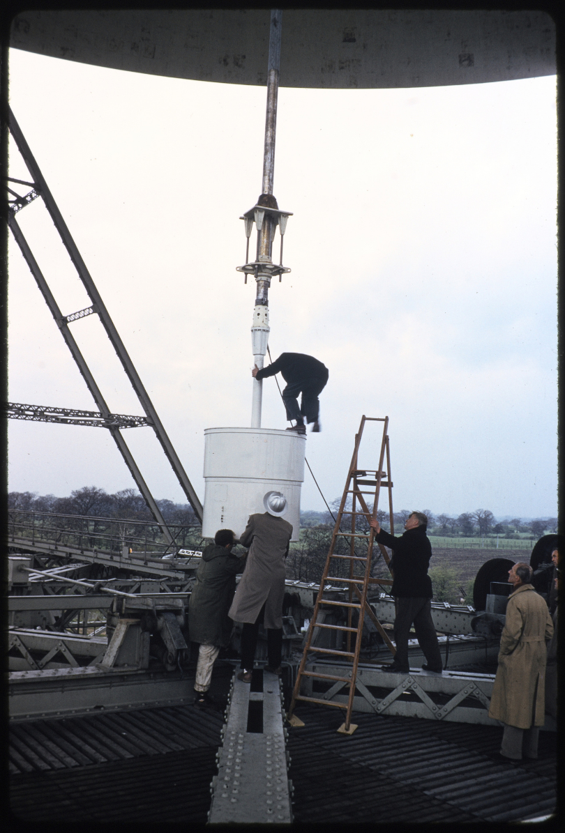 A gentleman stood at the top of a spire in the Lovell Telescope