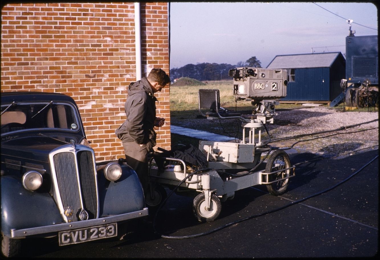 A gentleman looking at a vintage camera