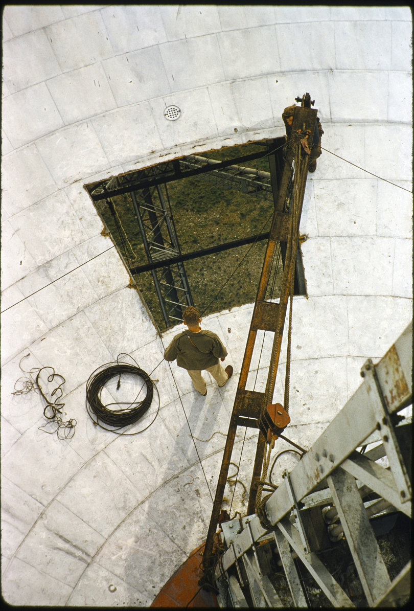 A gentleman looking through a gap in the dish of the Lovell Telescope