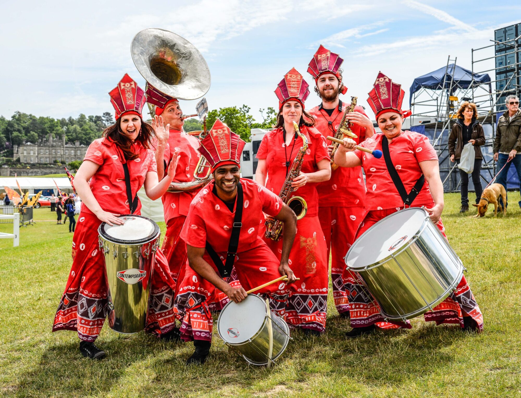 Global Grooves, a drum and brass band wearing red decorative attire.