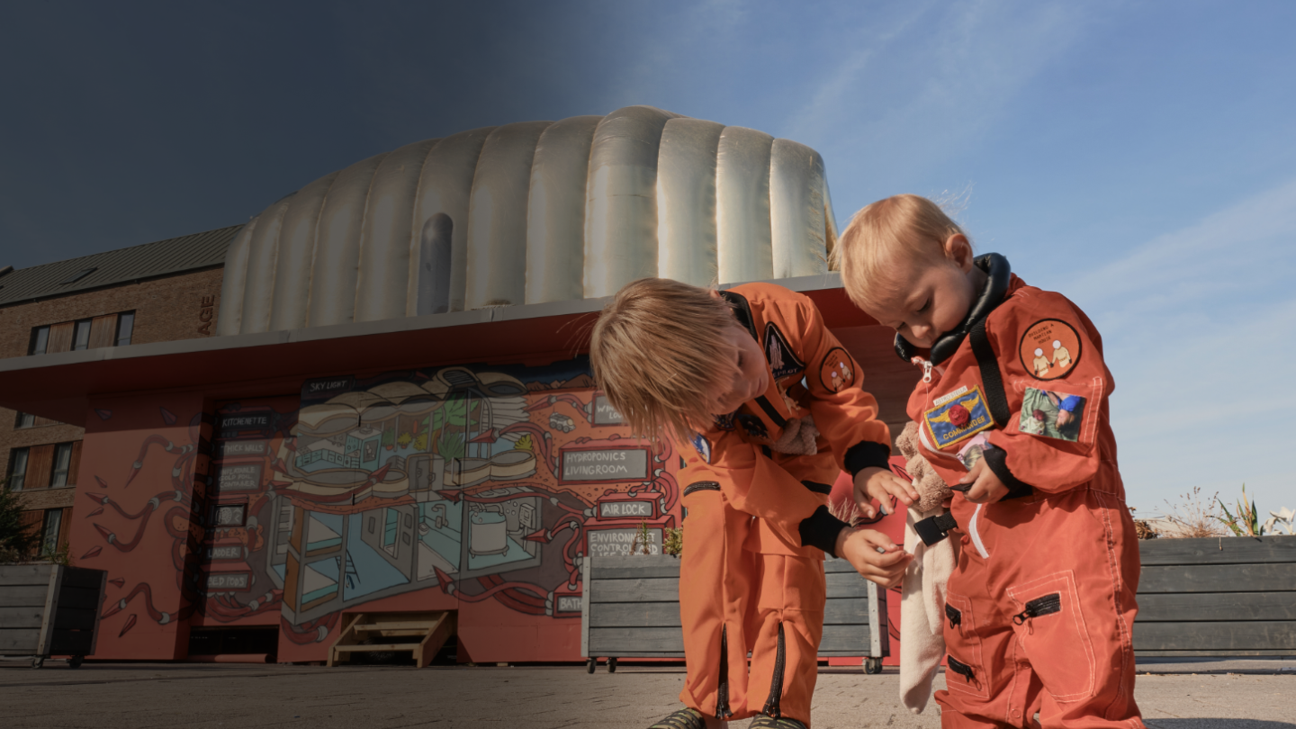 A photo of two children in a Martian spacesuit.