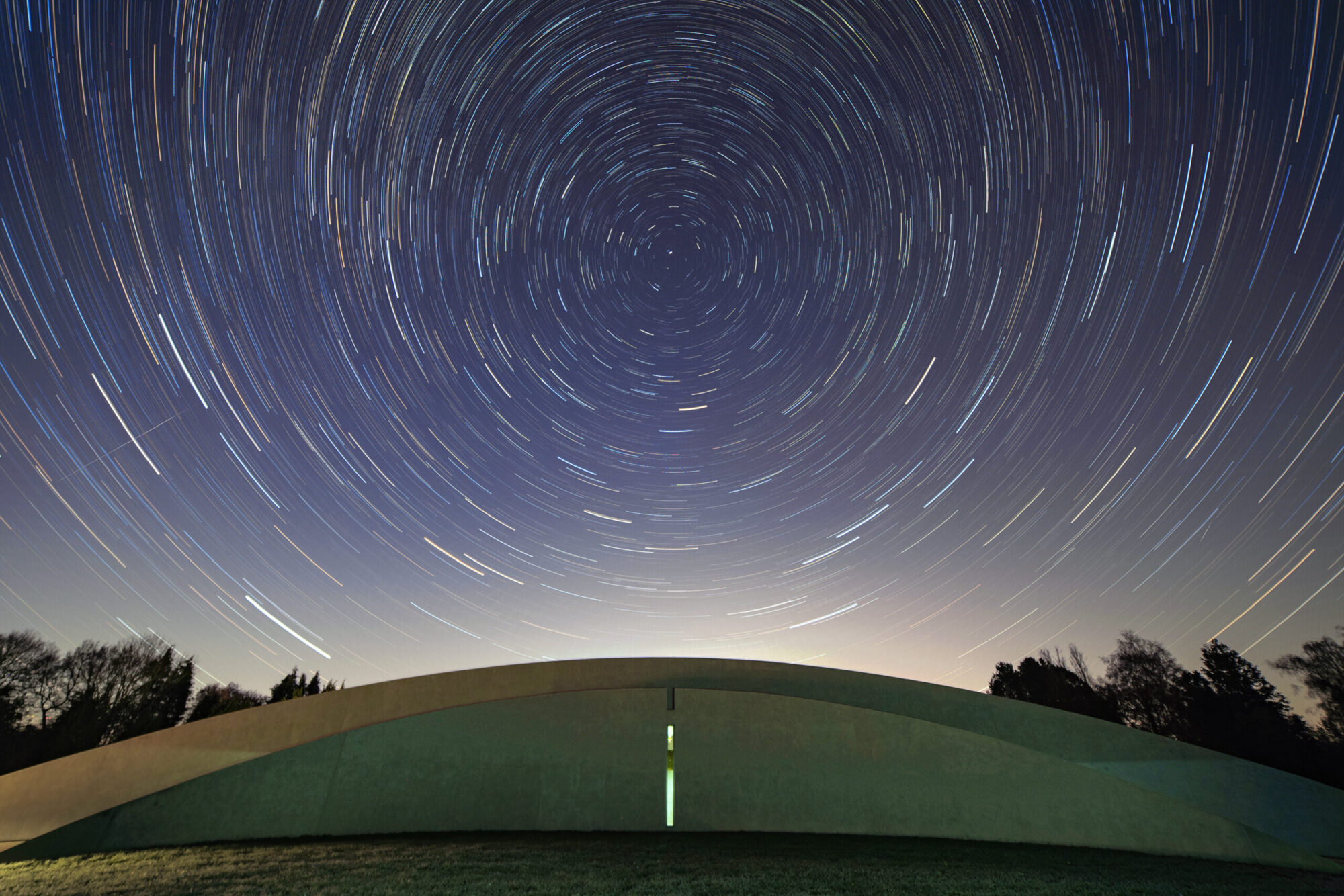 The First Light Pavilion at night, with stars overhead.